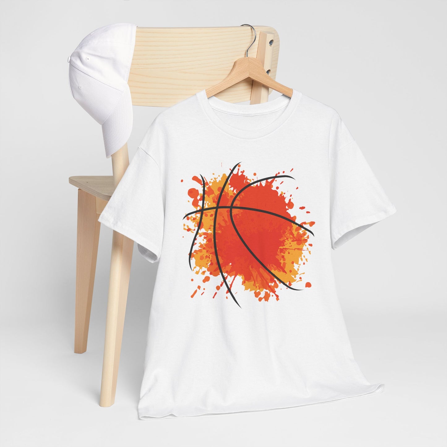 White celebration basketball t-shirt with abstract orange basketball design hanging on wooden hanger