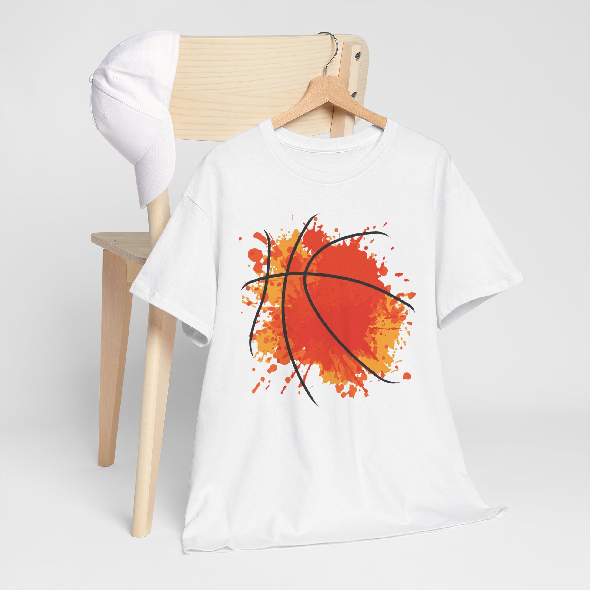 White celebration basketball t-shirt with abstract orange basketball design hanging on wooden hanger